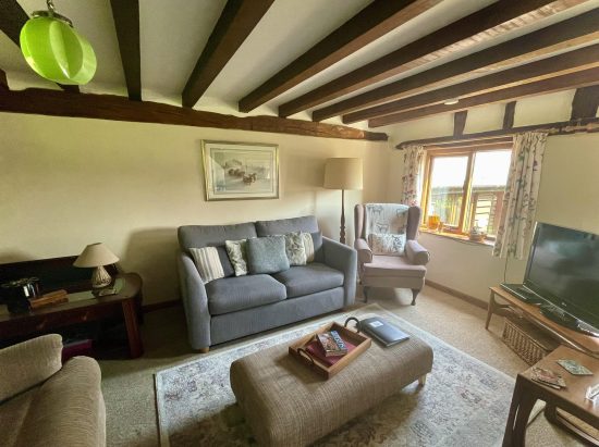 Living room with dual aspect views over gardens